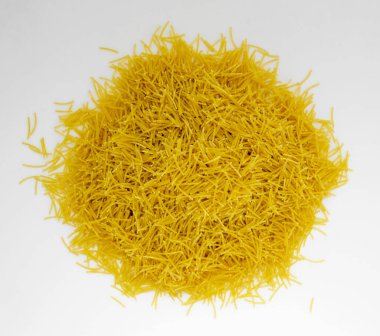 small durum wheat pasta for cooking and eating close-up on a white background