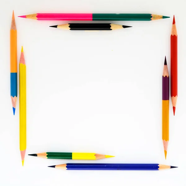 multi-colored graphite pencils in the form of a square frame on a white background