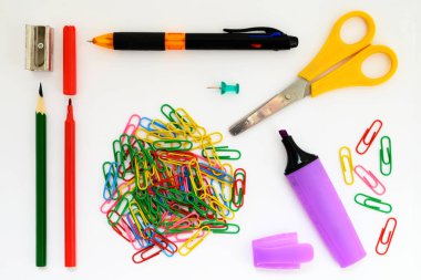 school supplies marker paper clips ruler pen scissors and pencil closeup white background wallpaper