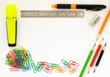 school supplies marker paper clips ruler pen and colored pencils close-up on white background