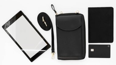 black style wallet passport credit card and tablet closeup on white background