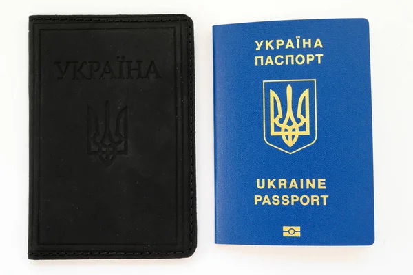 biometric passport of Ukraine and a black cover for a passport made of eco-leather close-up on a white background