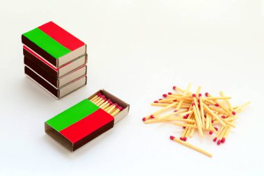 matchboxes and wooden matches with pink gray close up on white background