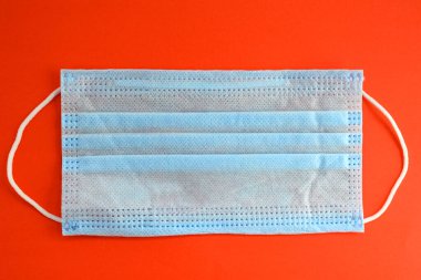 surgical mask with rubber straps fastened over the ears