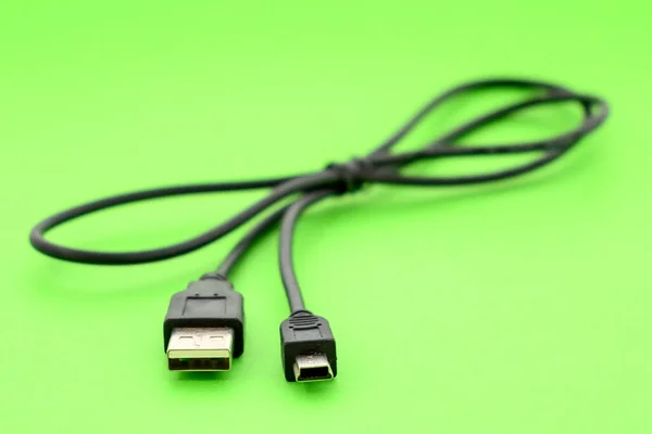 mini usb to usb 2.0 black cable close-up on a green background