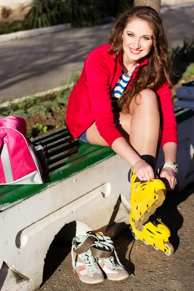 Pretty teenage girl with yellow roller-skates — Stock Photo, Image