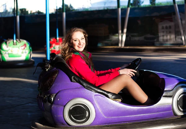 Teenage girl in an electric bumper car — Stock Photo, Image