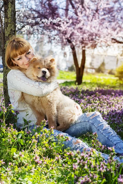 Portrait of a woman with her dog outdoors — Stock Photo, Image