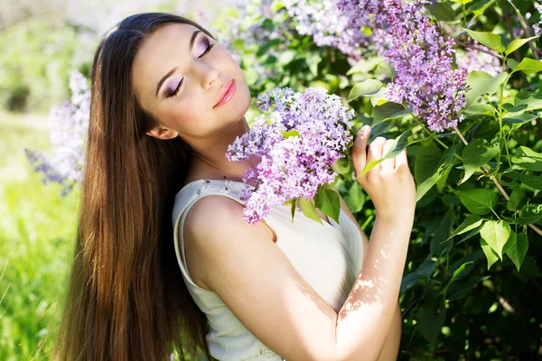 Bella ragazza con fiori lilla — Foto Stock