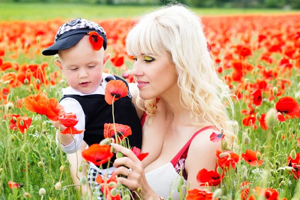 Happy mother and son on the poppies field — Stock Photo, Image