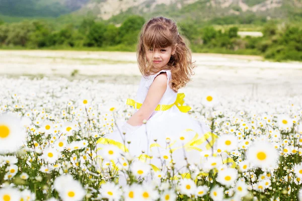 Cute child girl at camomile field — Stock Photo, Image