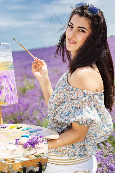 Young artist painting in lavender field — Stock Photo, Image