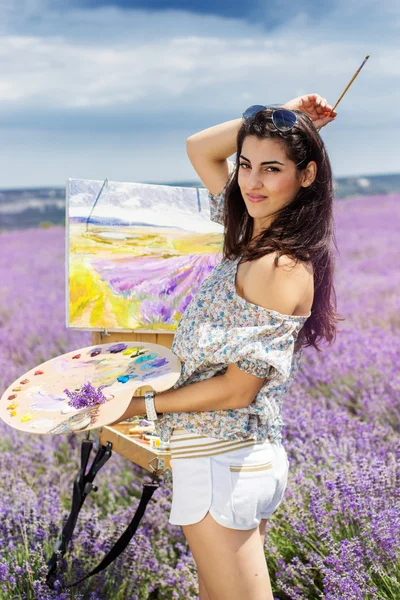 Young artist painting in lavender field — Stock Photo, Image