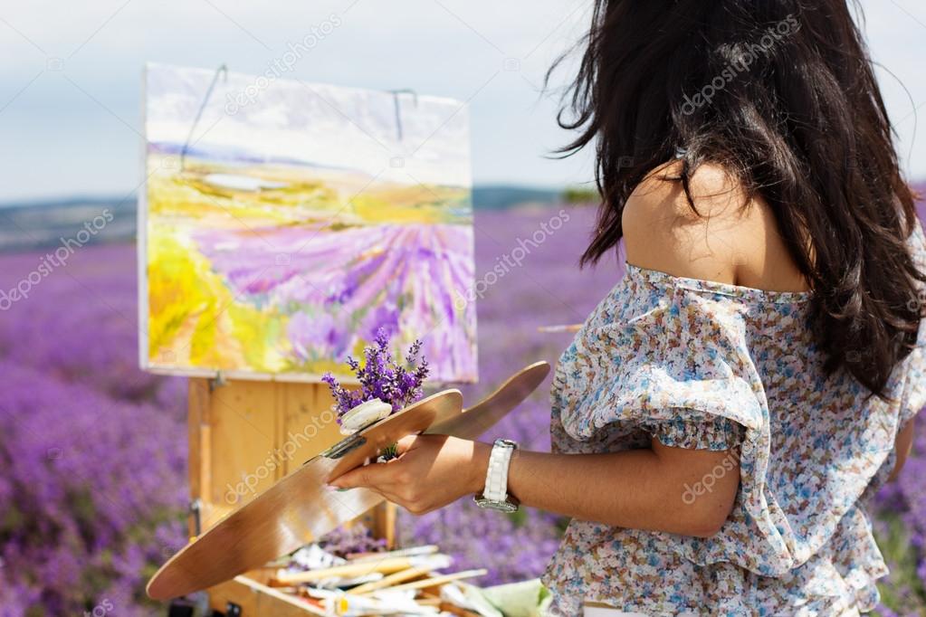 Young artist painting in lavender field