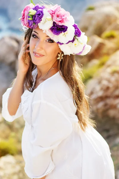 Beautiful young woman with wreath of flowers — Stock Photo, Image