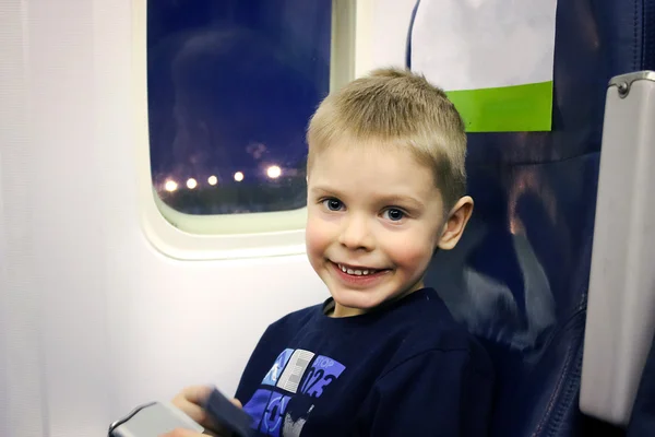 Happy little boy sitting inside the plane