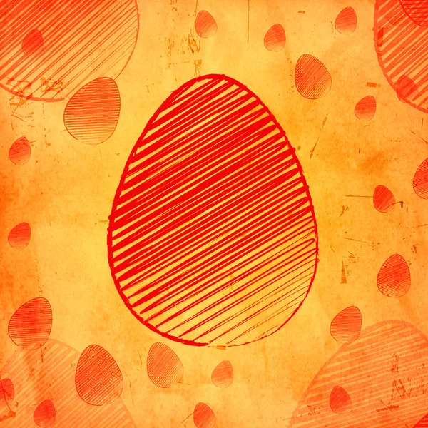 Оранжевое пасхальное яйцо на старом бумажном фоне с яйцами — стоковое фото