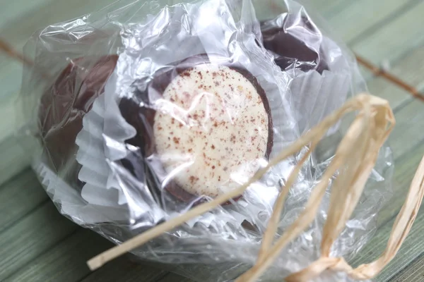 Chocolate pralines in a plastic present bag — Stock Photo, Image