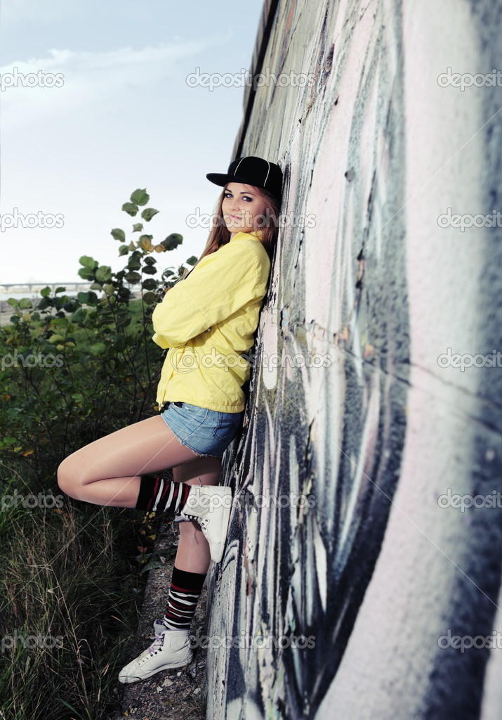 Young Urban Teenage Girl near Wall