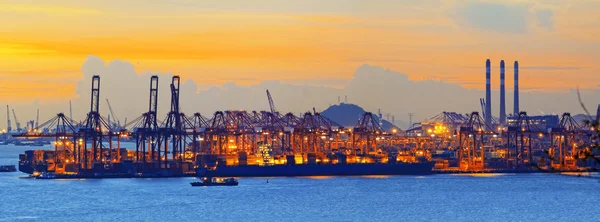 Silhouette of several cranes in a harbor, shot during sunset. — Stock Photo, Image