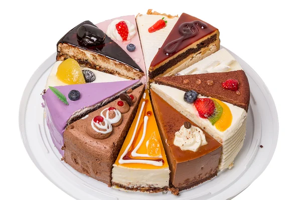 Дванадцять різних шматків торта на білому — стокове фото
