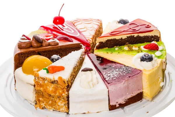 Different pieces of cake on white — Stock Photo, Image