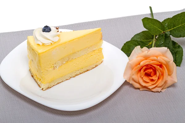 Rose and a piece of cake with blueberries — Stock Photo, Image