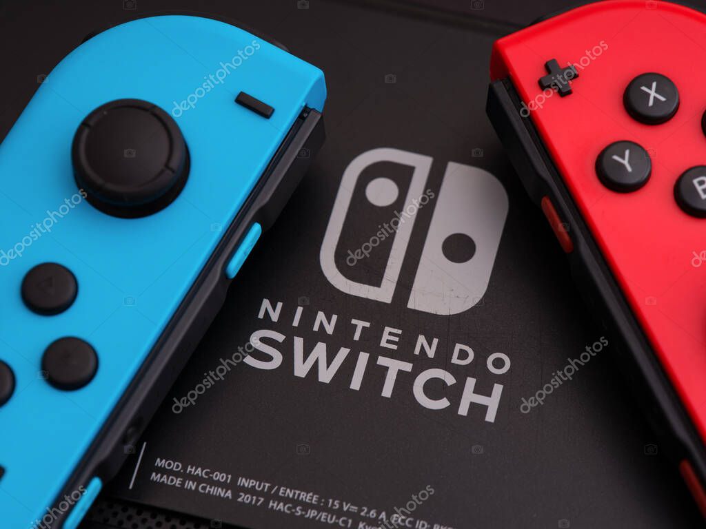 Tambov, Russian Federation - September 28, 2021 Back of Nintendo Switch video game console with Nintendo Switch logo and two Joy-Cons (red and blue).