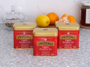 Tambov, Russian Federation - December 21, 2021 Three Twinings English Breakfast Tea metal boxes on kitchen table
