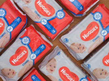Tambov, Russian Federation - December 21, 2021 A lot of Huggies wet wipes packs on the wooden background 