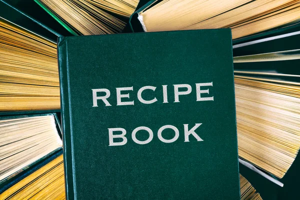 Top view of old hardcover books with Recipe Book on top.