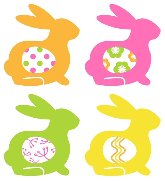 Colorful easter bunnies with eggs isolated on white — Stock Vector