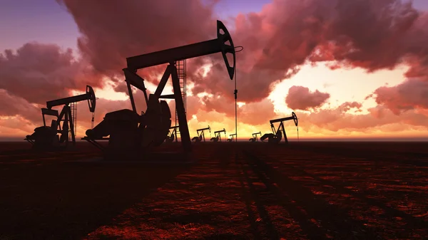 Campo petrolífero ao pôr do sol — Fotografia de Stock