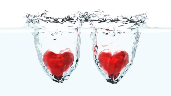 Dois corações vermelhos caindo na água — Fotografia de Stock