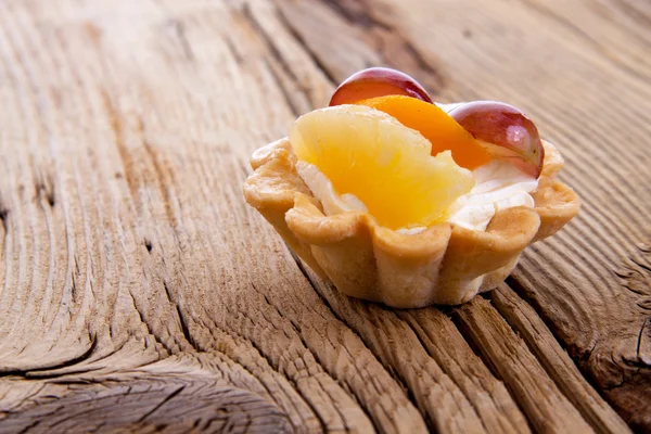 Basket fruit cake on wooden background Stock Photo