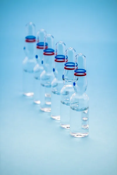Ampolle su fondo blu — Foto Stock