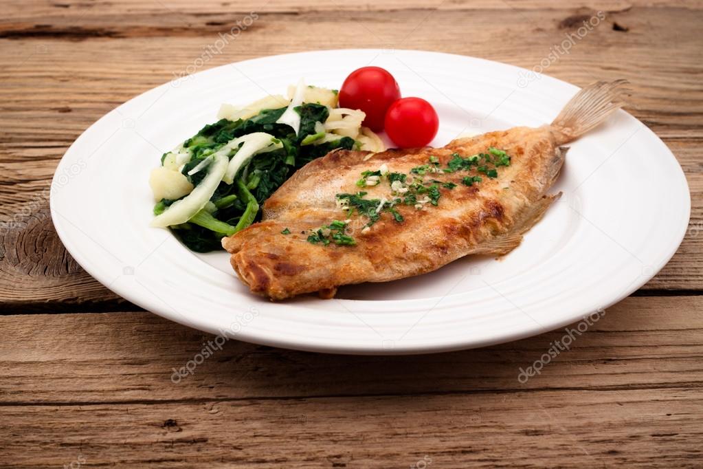 Fried flounder with onion, cabbage and potato