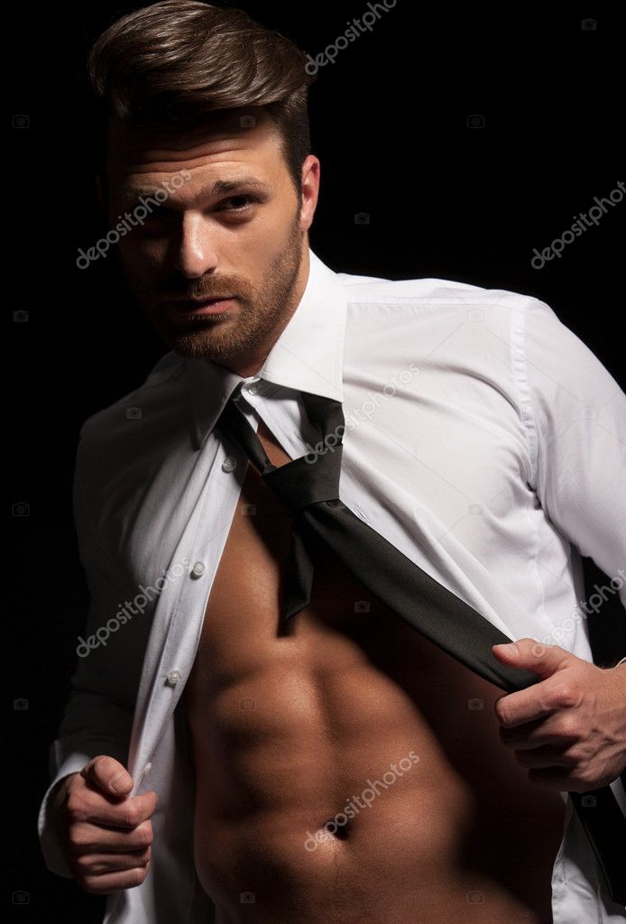 Man in suit showing abs a result of hard workout — Stock Photo