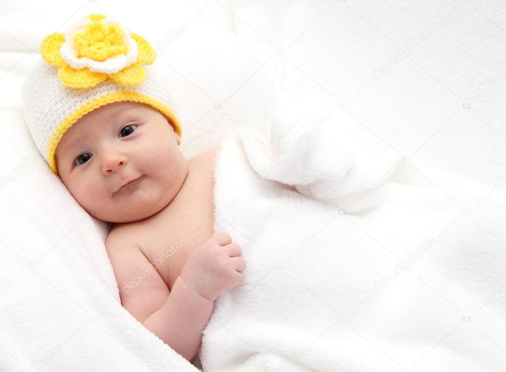 Little baby in knitted white hat