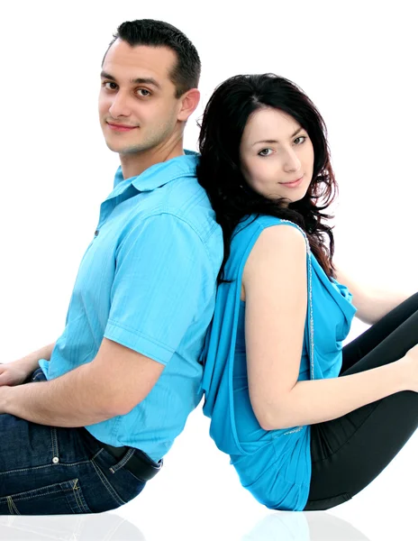 Man and woman sitting on ground and look at the camera — Stock Photo, Image