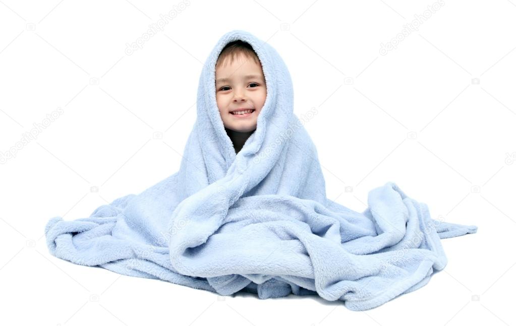 Child after bath sitting on bed