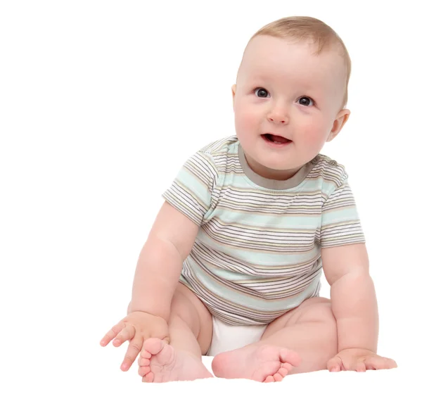 Hermoso niño feliz riéndose sentado en la cama blanca Fotos De Stock Sin Royalties Gratis