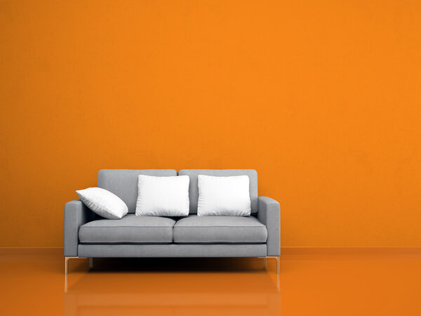 Modern grey sofa on the orange wall