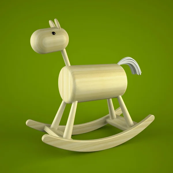 Дерев'яна коняча іграшка на зеленому фоні — стокове фото
