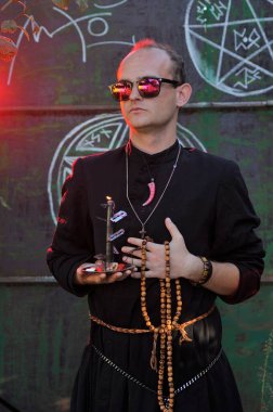 Rahip gibi giyinmiş bir adam. Cadılar Bayramı resmi. Sihir eksikliği.