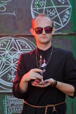 Rahip gibi giyinmiş bir adam. Cadılar Bayramı resmi. Sihir eksikliği.