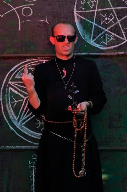 Rahip gibi giyinmiş bir adam. Cadılar Bayramı resmi. Sihir eksikliği.