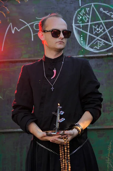 Rahip gibi giyinmiş bir adam. Cadılar Bayramı resmi. Sihir eksikliği.