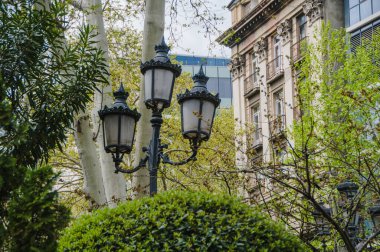 Bir bina parçası ve parkta bir şehir lambası. Klasik mimari.