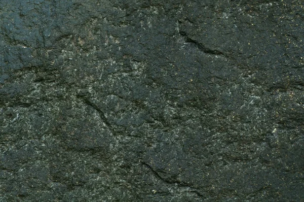 ロックだ 暗い石を閉じの背景のテクスチャ 上からの眺め ポティの堤防の石 — ストック写真